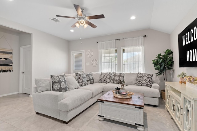 tiled living room with ceiling fan and lofted ceiling