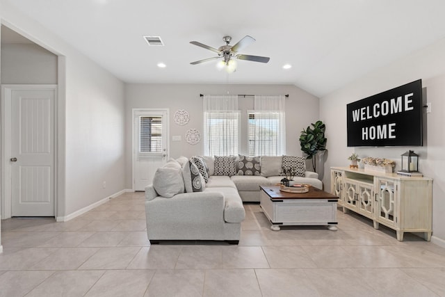 living room featuring ceiling fan, light tile patterned floors, and lofted ceiling