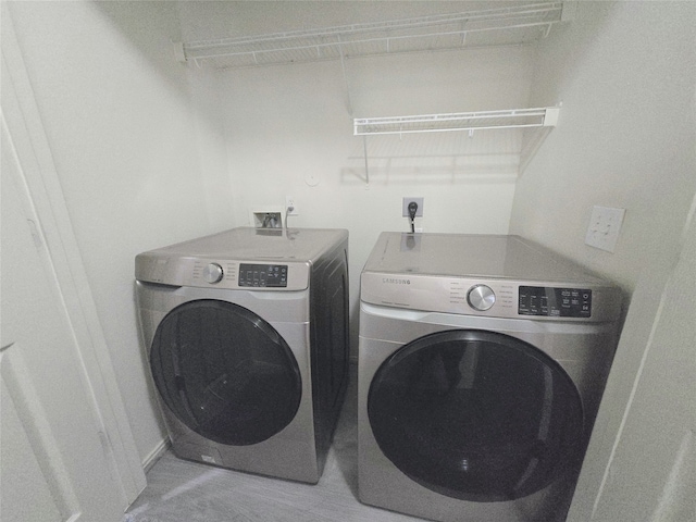 clothes washing area with washer and dryer