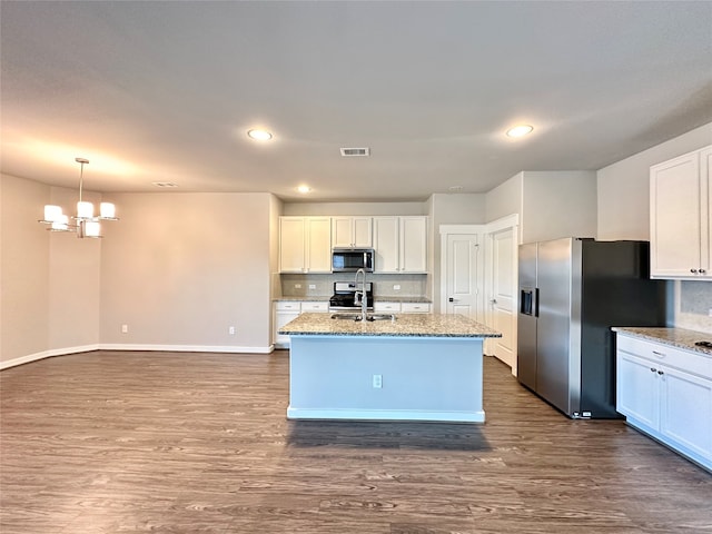 kitchen with stainless steel appliances, white cabinets, dark hardwood / wood-style floors, and sink