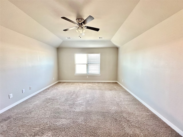 carpeted spare room with lofted ceiling and ceiling fan