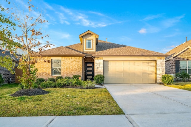 view of front of house with a garage and a front lawn