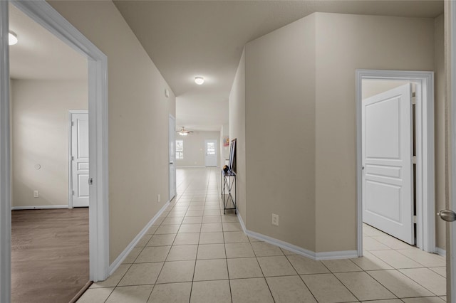 hall featuring light tile patterned flooring