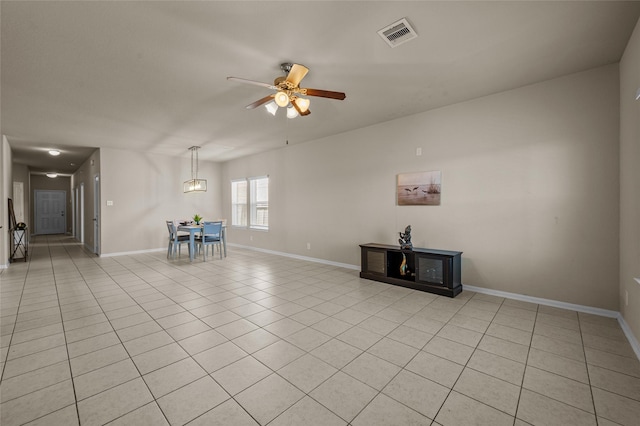 unfurnished living room with ceiling fan and light tile patterned floors