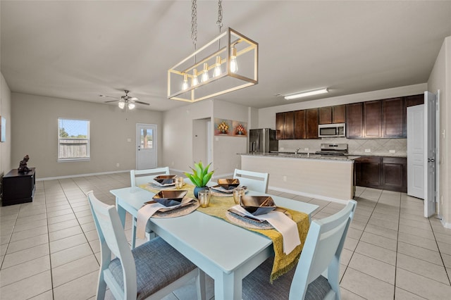 tiled dining space with ceiling fan