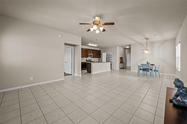 unfurnished living room featuring ceiling fan and light tile patterned floors