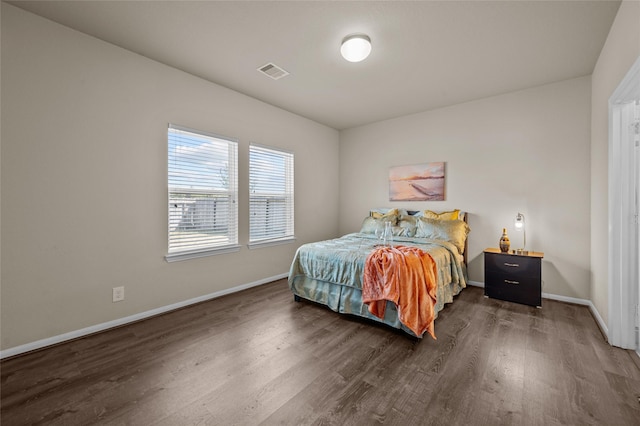 bedroom with dark wood-type flooring