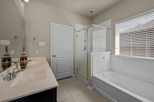 bathroom featuring vanity, shower with separate bathtub, and tile patterned floors