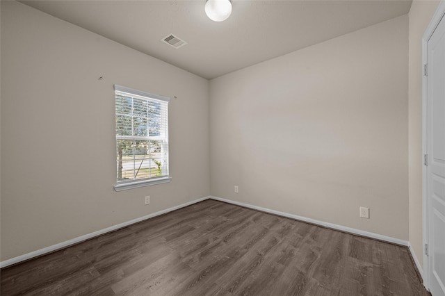 unfurnished room with hardwood / wood-style flooring