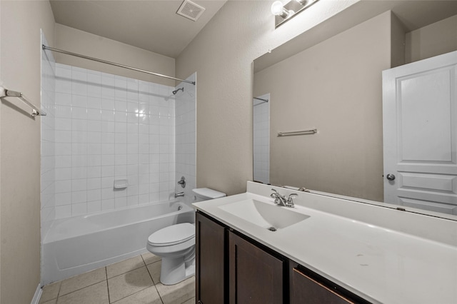 full bathroom with toilet, tiled shower / bath, tile patterned floors, and vanity