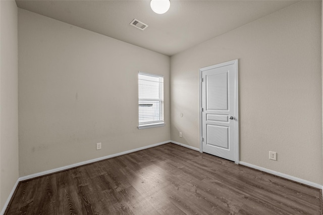 spare room featuring wood-type flooring