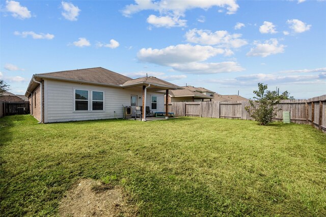 rear view of property with a yard