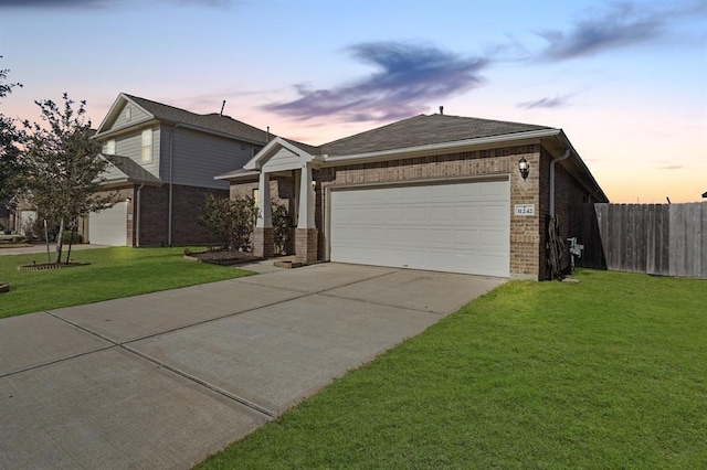 view of front of house featuring a garage and a yard