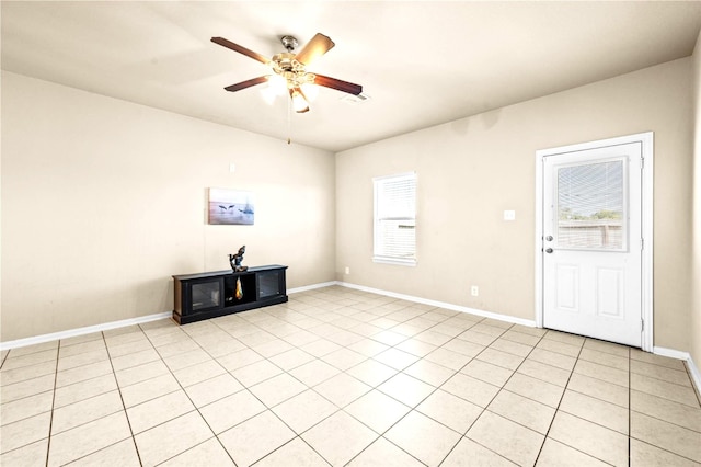 unfurnished living room with ceiling fan and light tile patterned floors