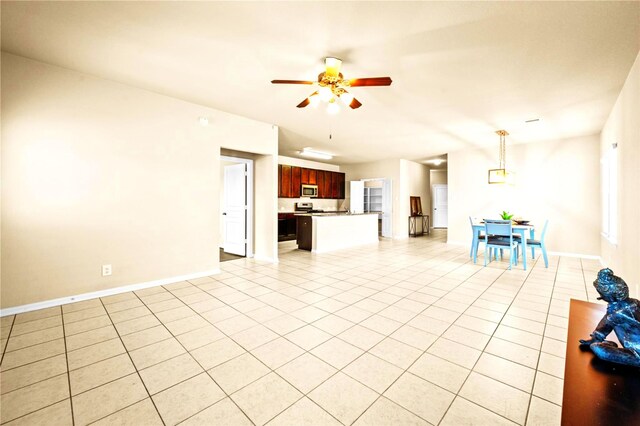 unfurnished living room featuring ceiling fan and light tile patterned flooring