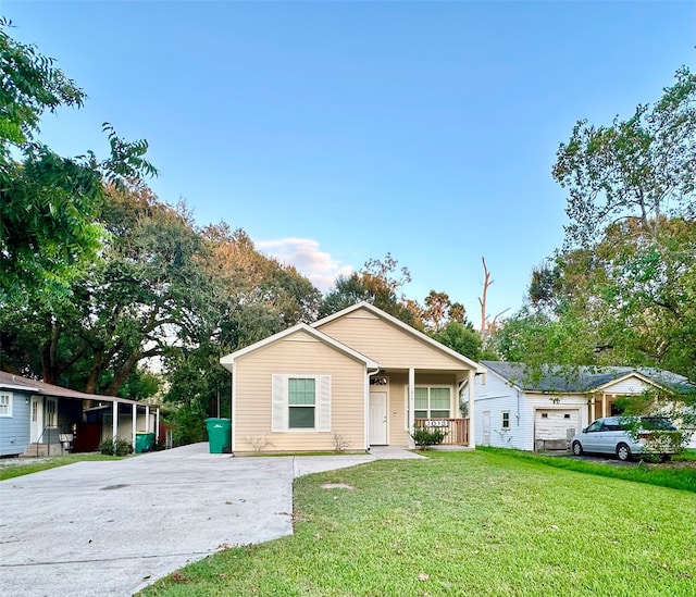 view of front of home featuring a garage, a front lawn, and covered porch