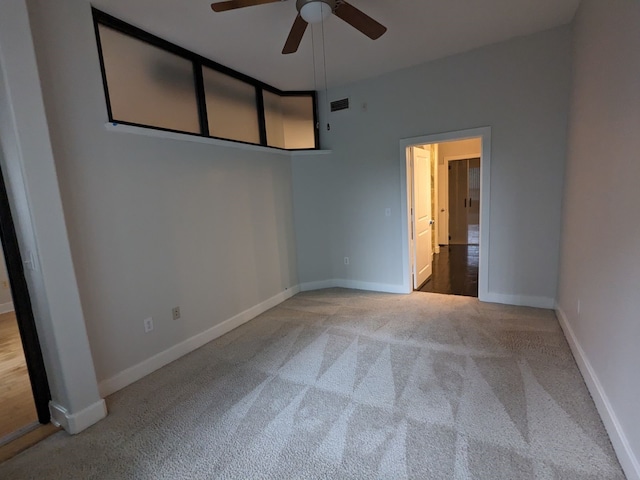 carpeted empty room featuring ceiling fan