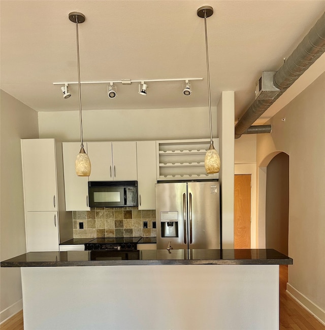 kitchen with black appliances, pendant lighting, white cabinetry, and backsplash