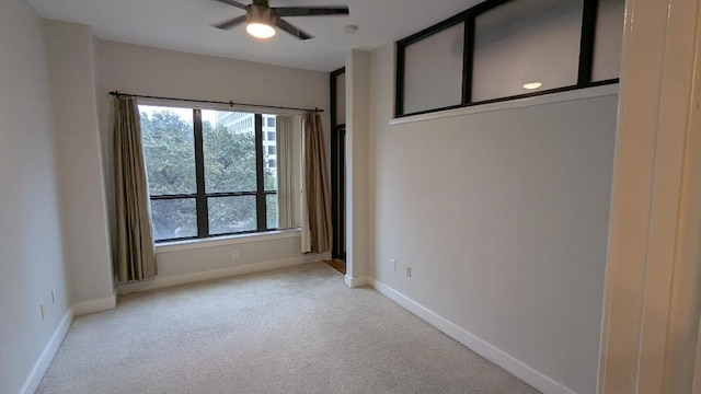 carpeted empty room featuring ceiling fan