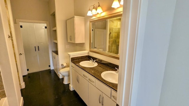 bathroom featuring vanity, toilet, and a notable chandelier