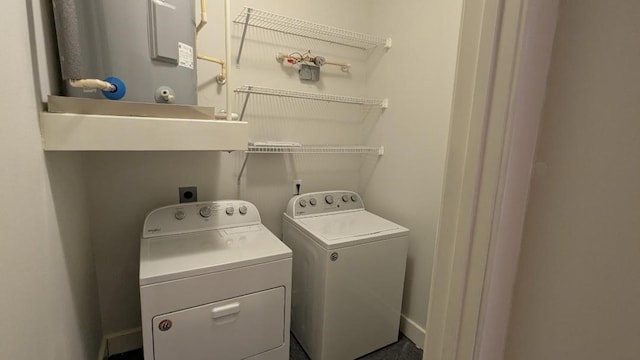 laundry area with washing machine and dryer and water heater