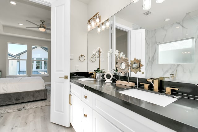 bathroom featuring hardwood / wood-style flooring, vanity, and ceiling fan