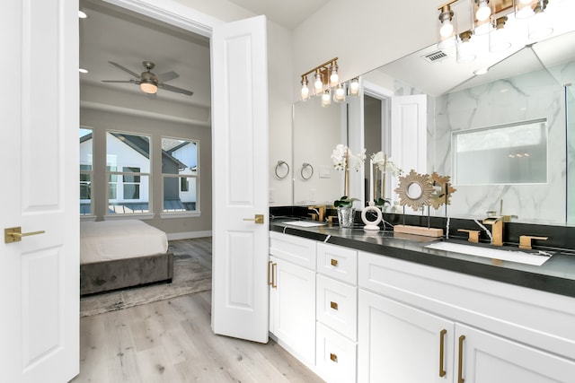 bathroom featuring vanity, wood-type flooring, a shower, and ceiling fan