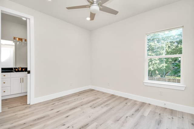 unfurnished bedroom featuring multiple windows, light wood-type flooring, and ceiling fan