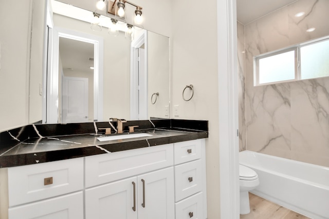 full bathroom featuring hardwood / wood-style flooring, vanity, toilet, and bathtub / shower combination