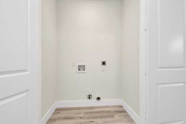 laundry room featuring hookup for a washing machine, electric dryer hookup, and light hardwood / wood-style flooring