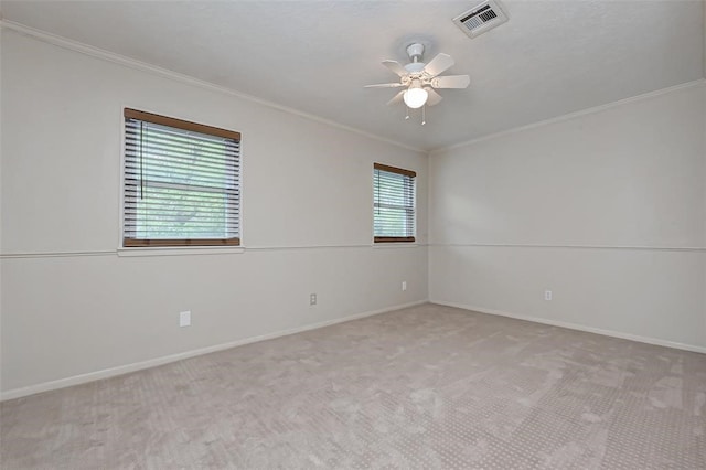 carpeted empty room with ceiling fan and ornamental molding