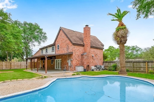 view of swimming pool featuring a lawn and a patio area