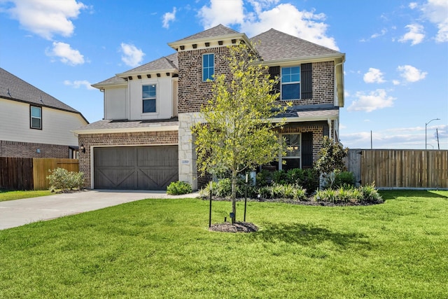 view of front of home featuring a front yard and a garage