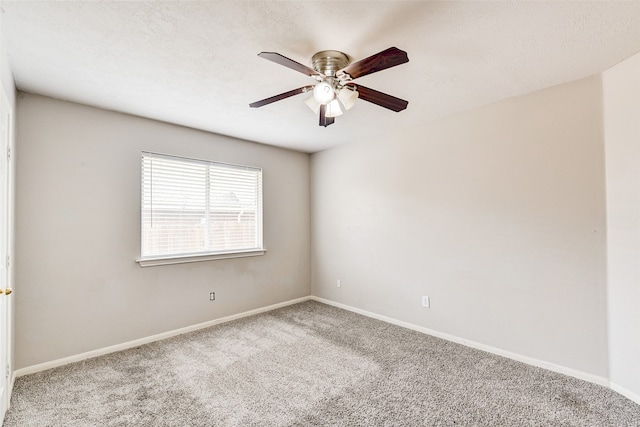 carpeted spare room with ceiling fan and a textured ceiling