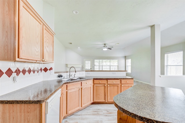 kitchen with dishwasher, light brown cabinetry, sink, and tasteful backsplash