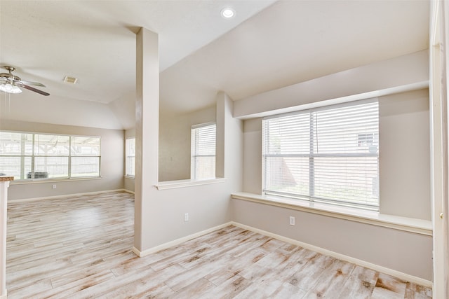 empty room with light hardwood / wood-style flooring, lofted ceiling, and ceiling fan