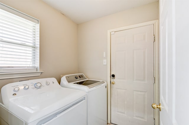 clothes washing area with washer and clothes dryer