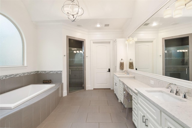 bathroom with a garden tub, vanity, ornamental molding, a shower stall, and tile patterned floors