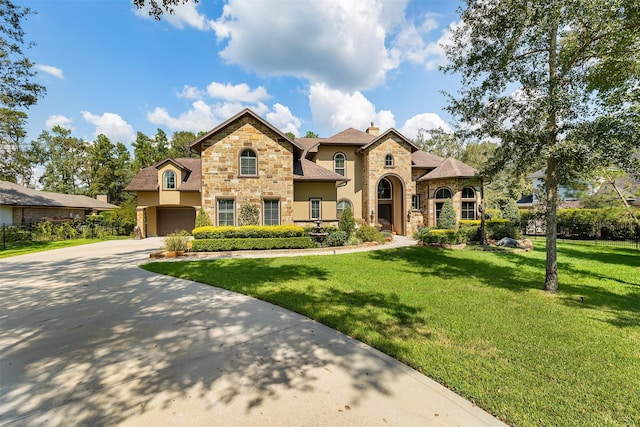 view of front of house with a garage and a front lawn