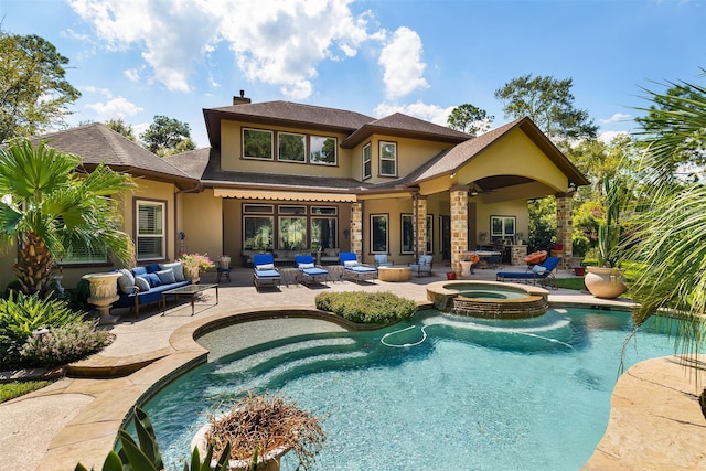 view of pool with an in ground hot tub, ceiling fan, outdoor lounge area, and a patio