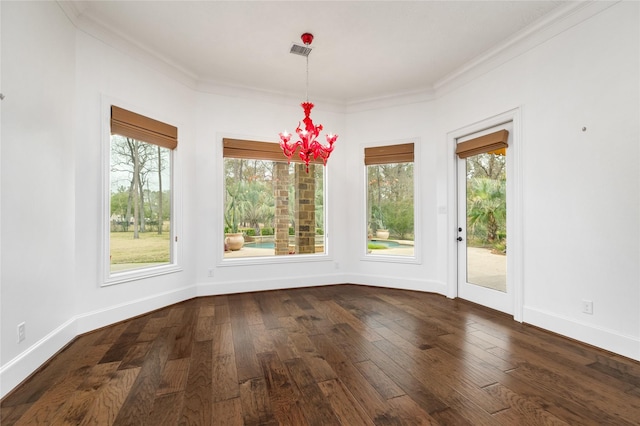 unfurnished dining area with dark wood-style floors, crown molding, baseboards, and a wealth of natural light