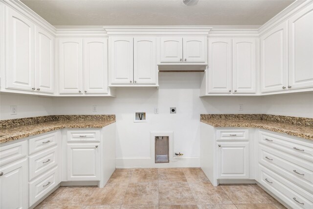 laundry room featuring gas dryer hookup, cabinets, washer hookup, and electric dryer hookup