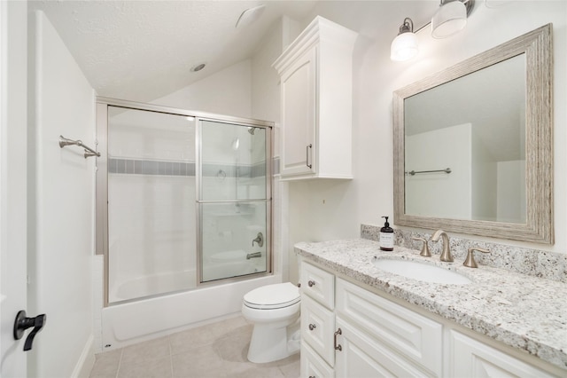 full bath with toilet, tile patterned floors, combined bath / shower with glass door, a textured ceiling, and vanity