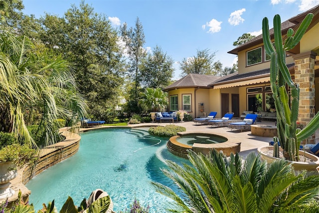 view of swimming pool with a patio area, a pool with connected hot tub, and an outdoor living space with a fire pit