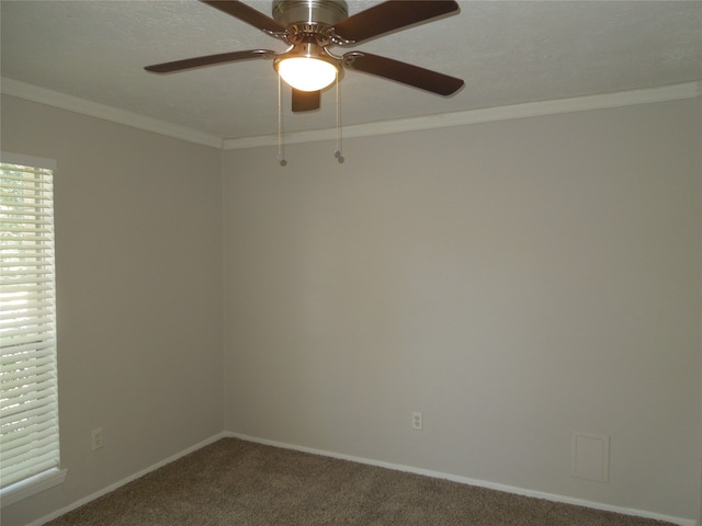 spare room featuring carpet floors, crown molding, and ceiling fan