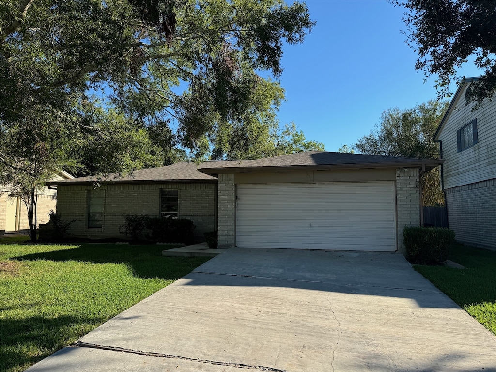 ranch-style house with a front yard and a garage