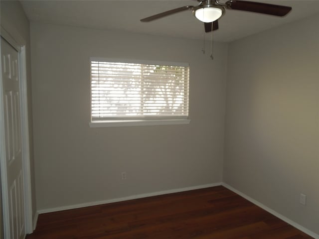 empty room featuring ceiling fan and dark wood-type flooring