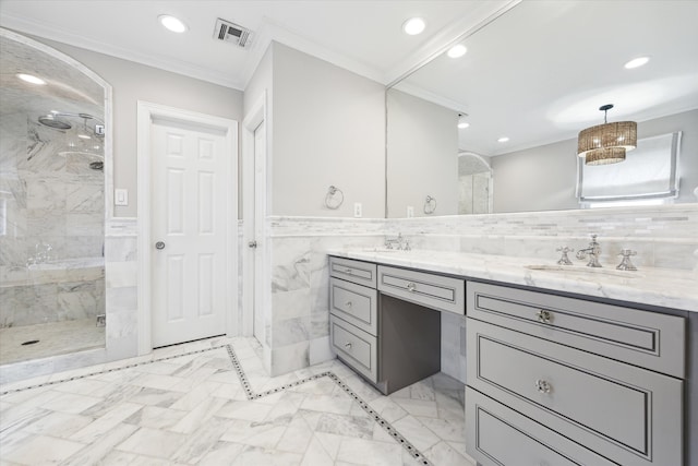 bathroom with ornamental molding, vanity, tile walls, and a shower with shower door