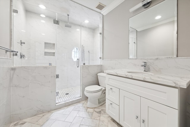 bathroom with tile walls, a shower with shower door, vanity, crown molding, and toilet