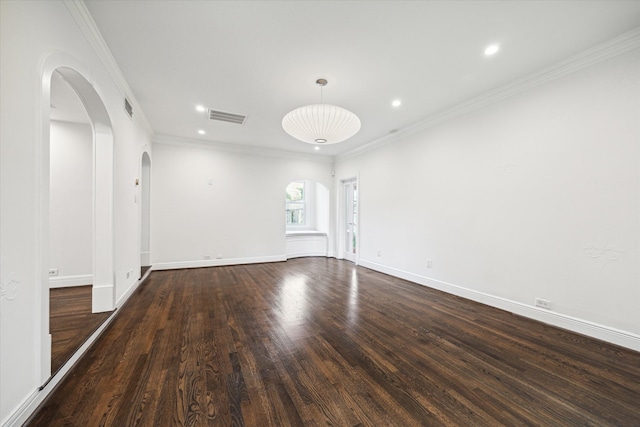 unfurnished room featuring ornamental molding and dark wood-type flooring